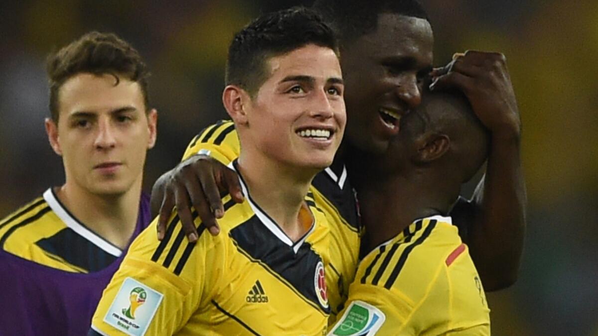 Colombia midfielder James Rodriguez, center, smiles after the team's 2-0 win over Uruguay at the World Cup on Saturday.