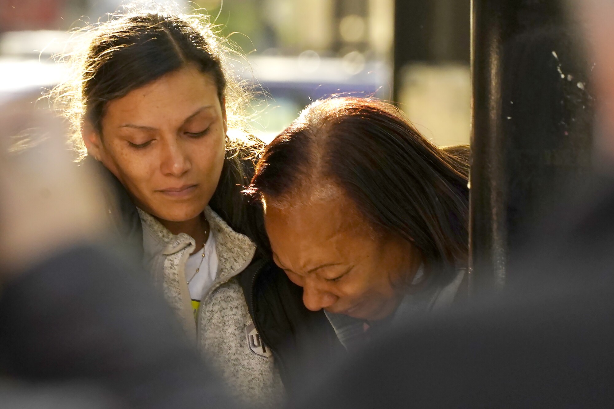 Leticia Harris, left, the wife of mass shooting victim Sergio Harris, consoles his mother, Pamela Harris 