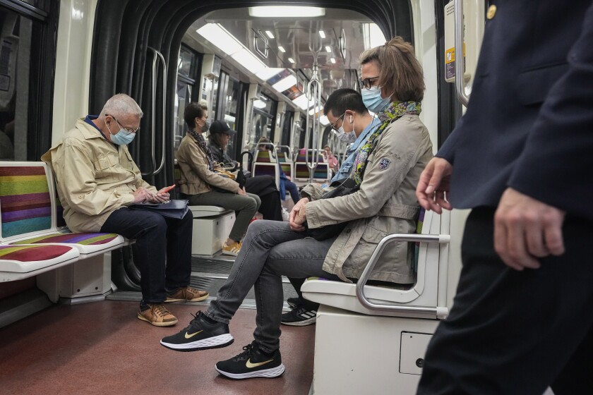 People wearing face masks to protect against COVID-19 ride a subway in Paris, Thursday, June 30, 2022. Virus cases are rising fast in France and other European countries after COVID-19 restrictions were lifted in the spring. With tourists thronging Paris and other cities, the French government is recommending a return to mask-wearing in public transport and crowded areas but has stopped short of imposing new rules. (AP Photo/Michel Euler)