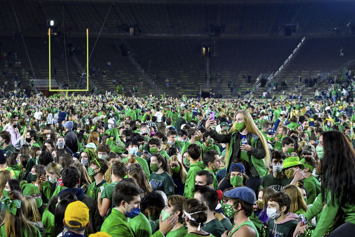 Notre Dame fans gather on the field to celebrate a 47-40 double-overtime victory against top-ranked Clemson.