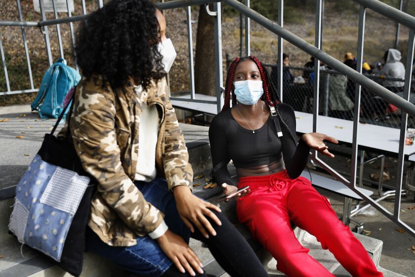 LOS ANGELES-CA-DECEMBER 6, 2021: Aleyia Willis, 17, right, hangs out with her friend Kaila London, 17, during lunch break at Downtown Magnets High School in Los Angeles on Monday, December 6, 2021. (Christina House / Los Angeles Times)
