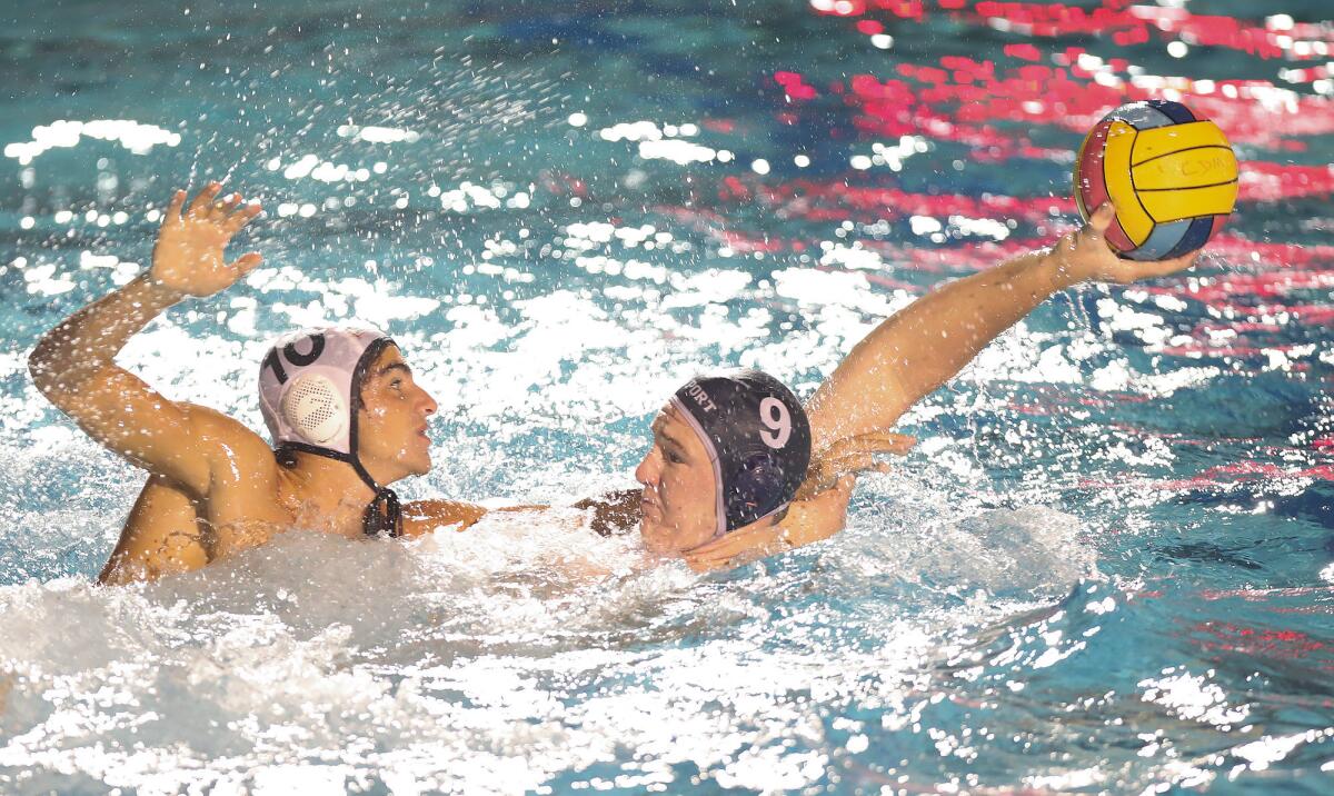 Newport Harbor's Ike Love (9) shoots and scores while Huntington Beach's Ryan Elkhouri defends in a Surf League match on Wednesday at Corona del Mar High.