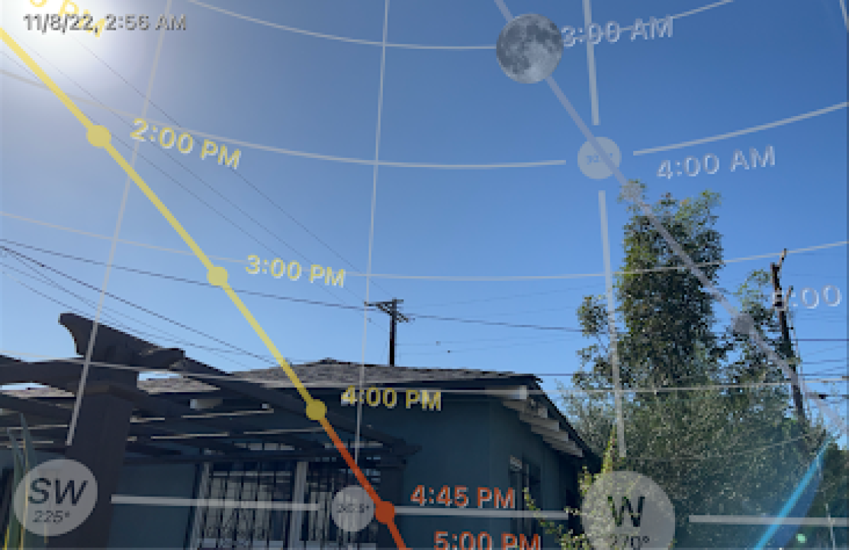 The PhotoPills app shows an Augmented Reality view of the path of the sun and moon for the selected date. 