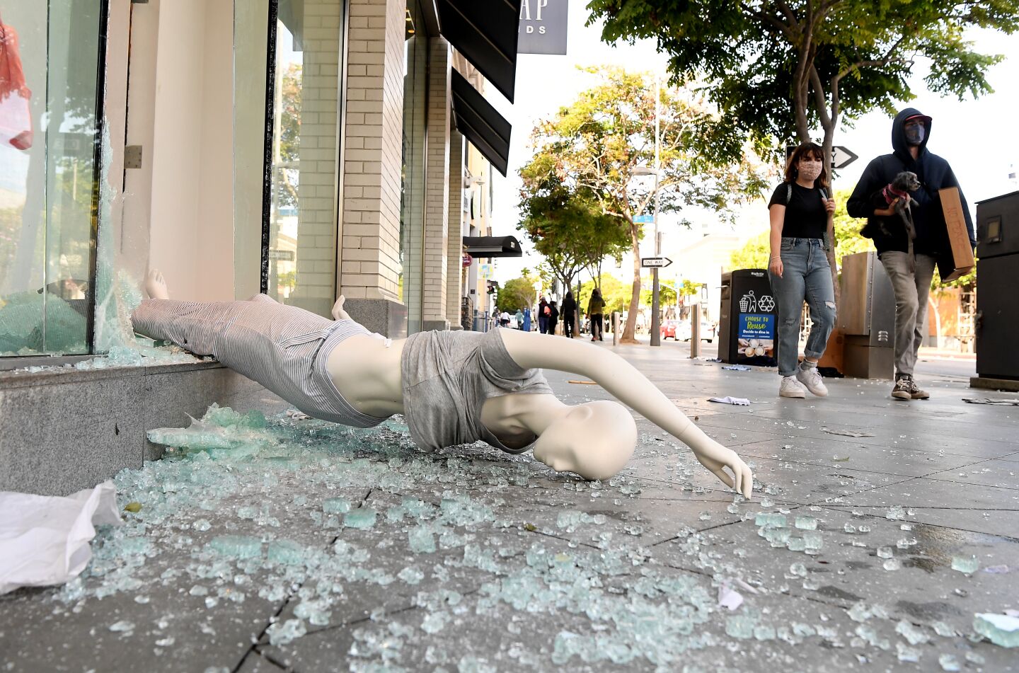 Broken glass from a looted store covers the sidewalk in Santa Monica.