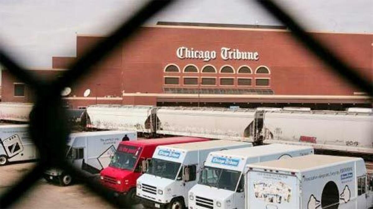 DISTRIBUTION: Trucks at the Chicago Tribune printing plant are ready to deliver papers throughout the city and suburbs. Decades ago, competition among the dailies was so intense that trucks would be hijacked and newspapers dumped into the Chicago River.