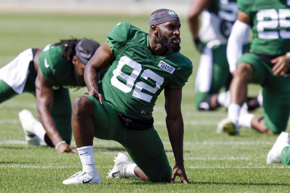 FILE - In this Aug. 18, 2021, file photo, New York Jets wide receiver Jamison Crowder stretches during a joint NFL football practice with the Green Bay Packers in Green Bay, Wis. Crowder is recovering from symptoms of COVID-19 and his status for the opening game at Carolina remains uncertain. Coach Robert Saleh said Monday, Sept. 6, 2021, that Crowder is vaccinated against the virus, but the receiver's availability for the season opener will depend on how he feels. As a vaccinated player, Crowder will also need to produce two negative tests 24 hours apart, per NFL protocols. (AP Photo/Matt Ludtke, File)
