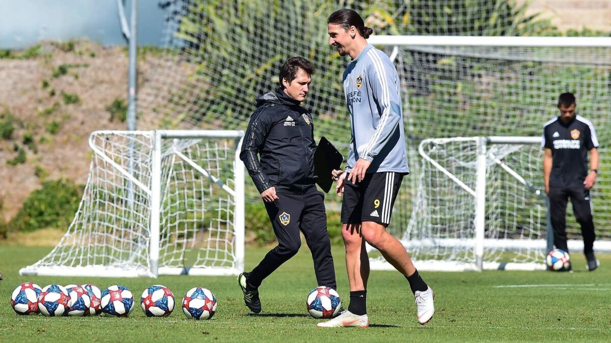 Galaxy forward Zlatan Ibrahimovic and coach Guillermo Barros Schelotto during a training session on Feb. 22 in Carson.