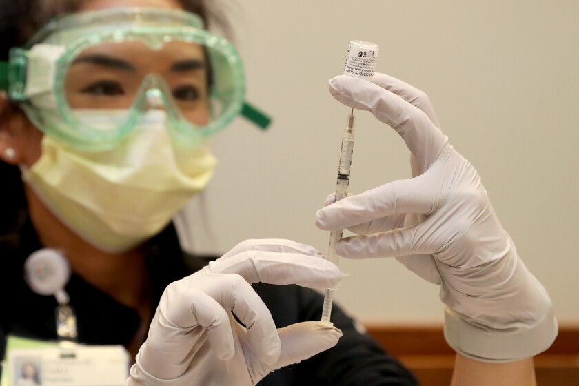 Clinical pharmacist Stephanie Chao fills a syringe.