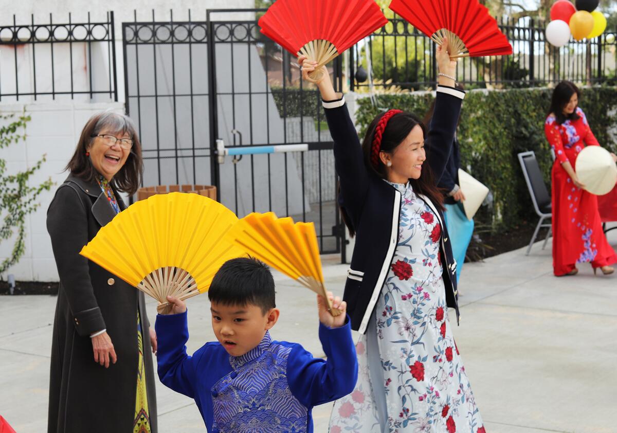 Christopher Nguyen, 5, of Garden Grove, learns a fan dance during the Lunar New Year Festival on Saturday in Fountain Valley.