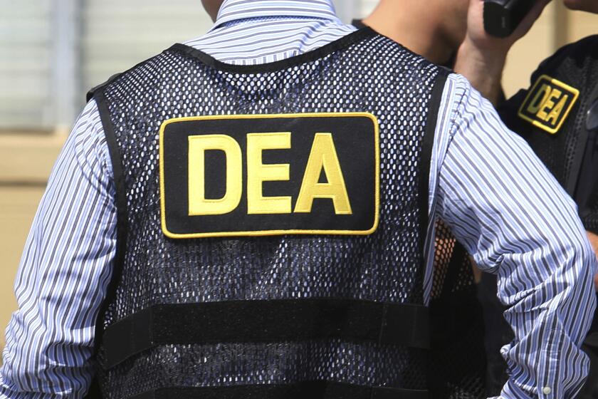 FILE - This June 13, 2016, file photo shows Drug Enforcement Administration agents in Florida. A current U.S. Drug Enforcement Administration agent and a former supervisor in the agency were indicted Friday, May 20, 2022 on federal charges accusing them of leaking confidential law enforcement information to defense lawyers in Florida in exchange for cash and gifts. (Joe Burbank/Orlando Sentinel via AP)