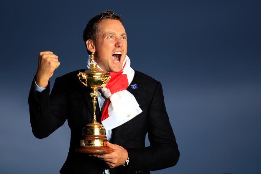 Ian Poulter of Europe poses with the Ryder Cup trophy on Sept. 28.