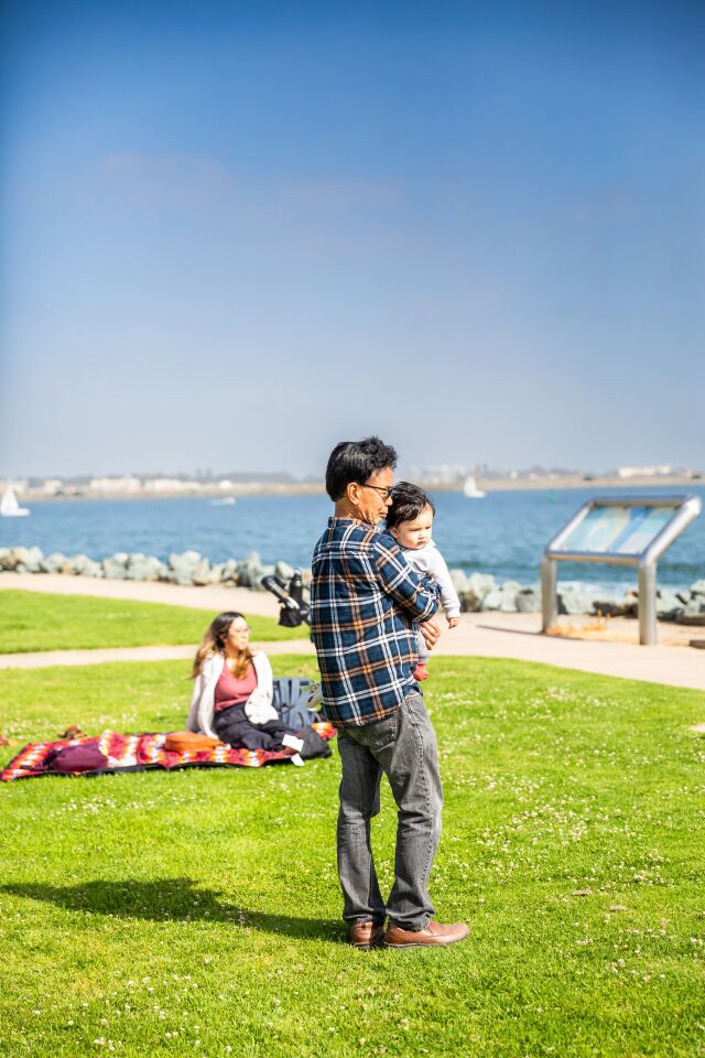 The Quans — Desiree, Rolando and baby Taylor — relax at Shoreline Park.