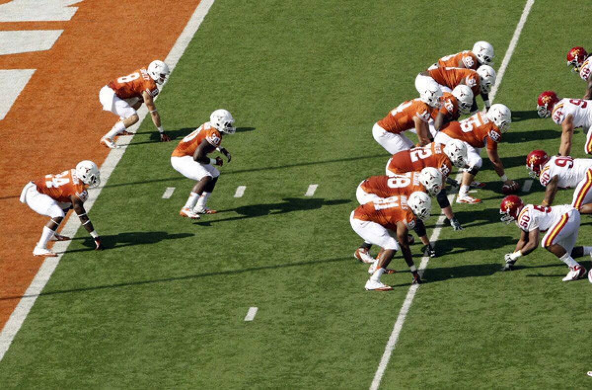 Texas lines up in the wishbone formation to run its first play from scrimmage against Iowa State on Saturday in honor of former coach Darrell Royal.