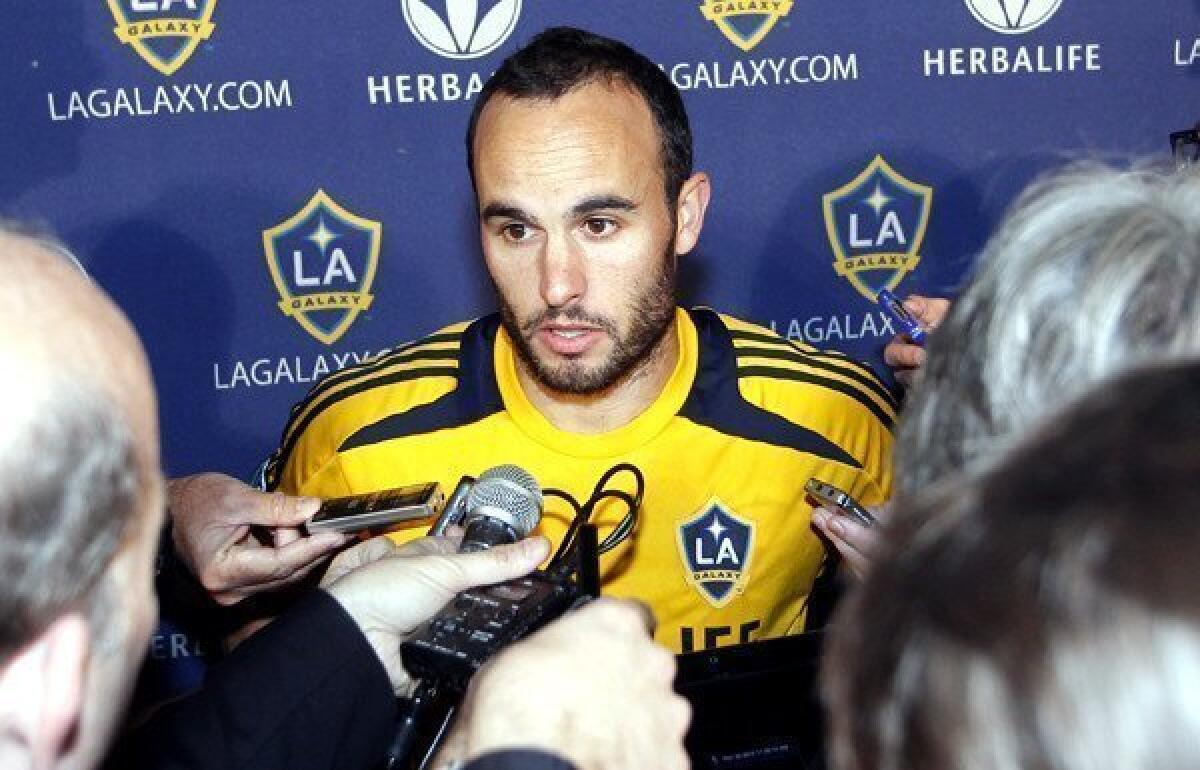 Galaxy star Landon Donovan talks with reporters at a news conference.