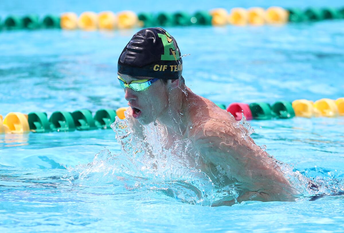 Edison's Coulter Dilts swims the breaststroke of the boys' varsity medley relay during the Wave League swim finals.