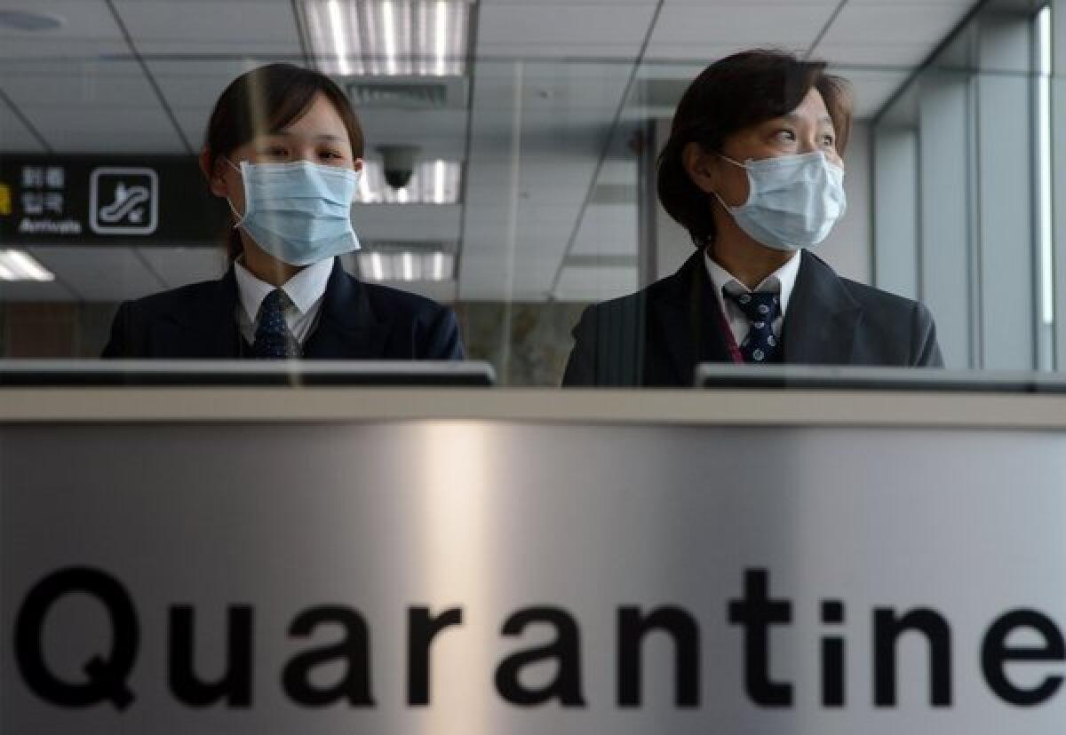 Staff from Taiwan's Center for Disease Control at Sungshan Airport in Taipei. Taiwan has raised its level of alert as new deaths from H7N9 bird flu have been reported.