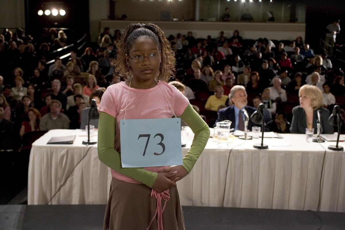 A girl wears a placard with the number 73 on it in a scene from the movie "Akeelah and the Bee."