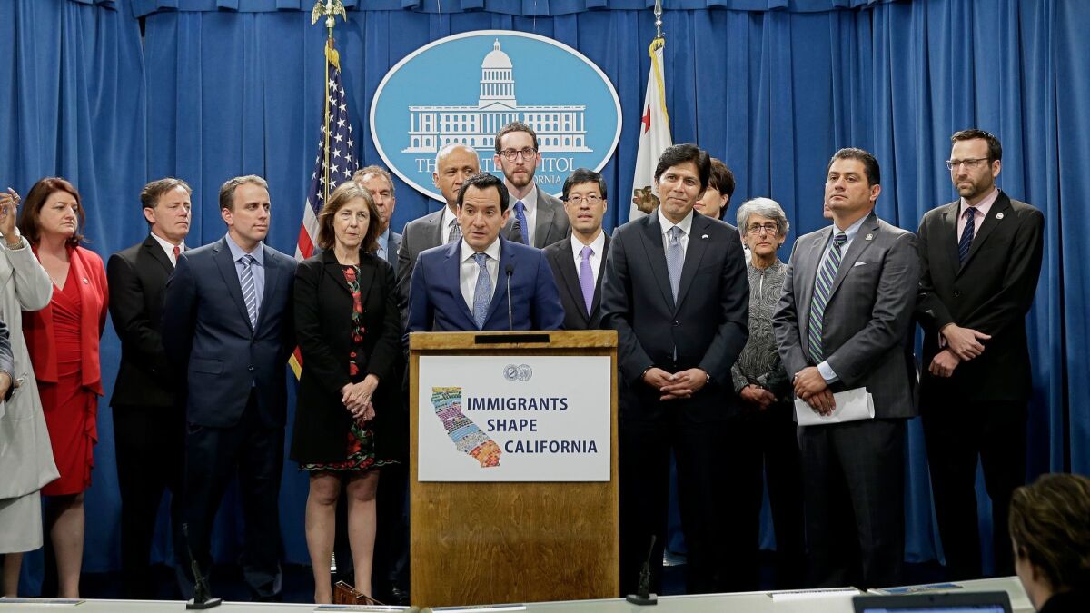 Assembly Speaker Anthony Rendon (D-Paramount), center, and Democratic lawmakers discuss proposed measures to protect immigrants during a December 2016 news conference in Sacramento.