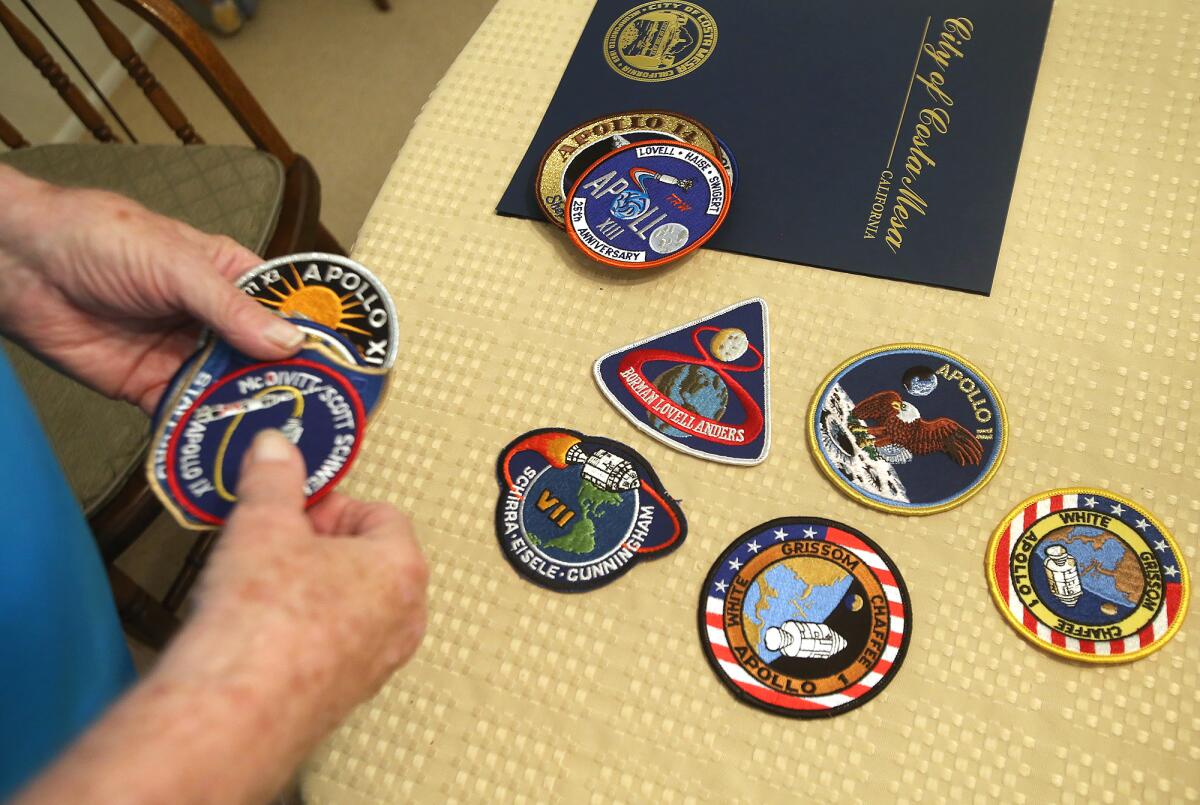 Retired rocket scientist Jerry Florey shows his collection of mission patches he earned while working in the Apollo space program.