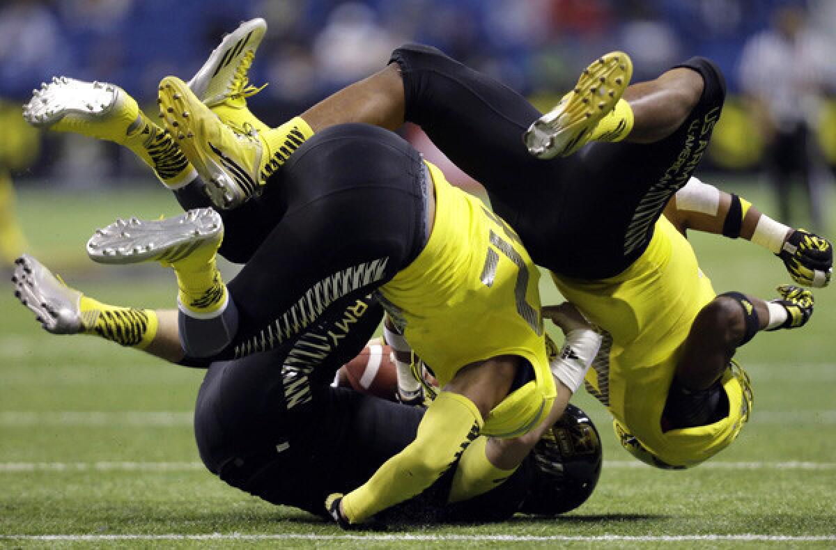 West linebacker Kenny Young (42) and teammate Nyles Morgan tackle East quarterback Jacob Park during U.S. Army All-American game in January.