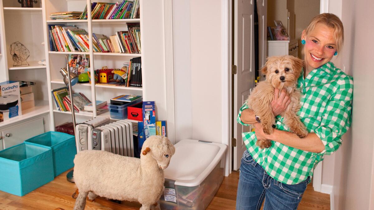 Meghan Kennihan with her dog, Maddie, in the finished basement of her home on April 20, 2016 in La Grange, Ill., where, as a millennial, she lives with her parents.