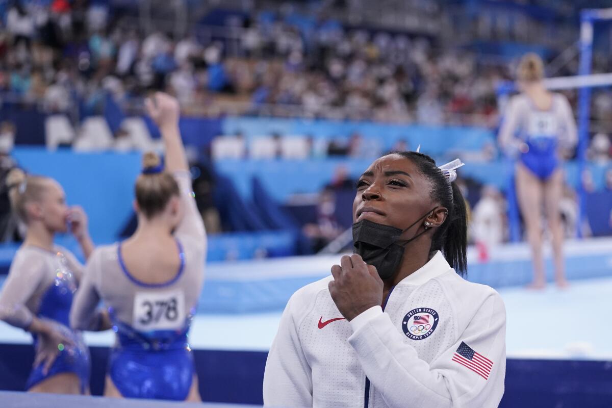 U.S. gymnast Simone Biles stands on the sideline after withdrawing from the women's team final.