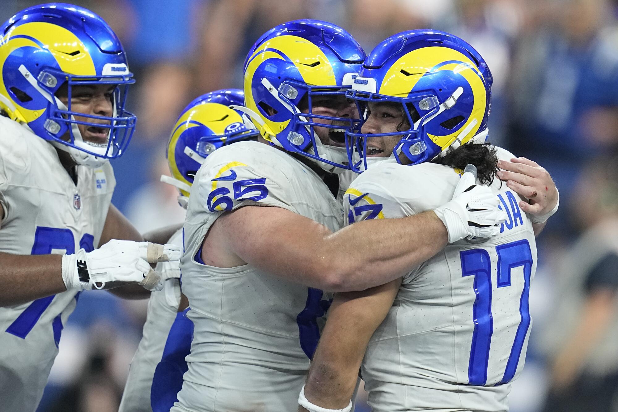 Rams rookie wide receiver Puka Nacua gets a hug from a teammate.