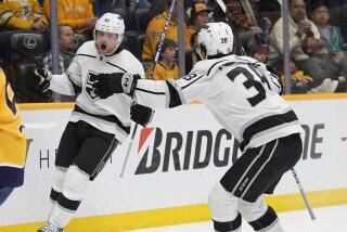Los Angeles Kings right wing Carl Grundstrom (91) celebrates a goal with center Alex Turcotte (38) during the first period of an NHL hockey game against the Nashville Predators, Wednesday, Jan. 31, 2024, in Nashville, Tenn. (AP Photo/George Walker IV)