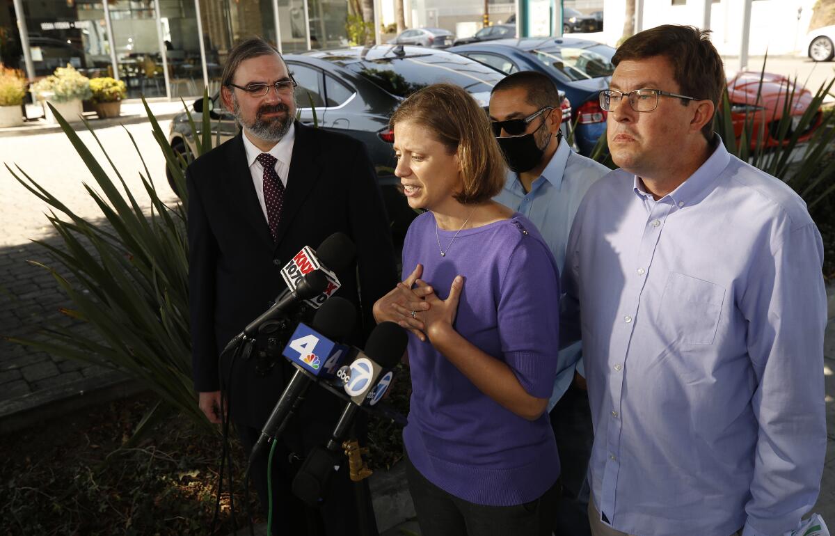 Attorney Robert Frommer with clients in a class-action lawsuit.