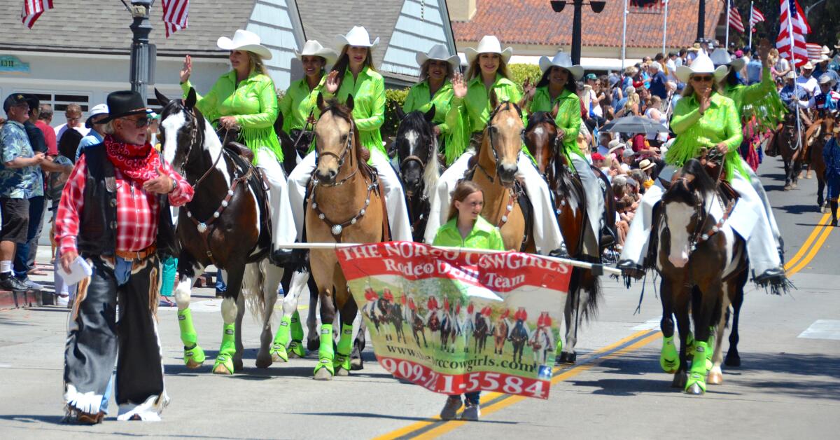 Parade chairman Jack Callahan rounds up the Norco Cowgirls Equestrian Rodeo Drill Team.