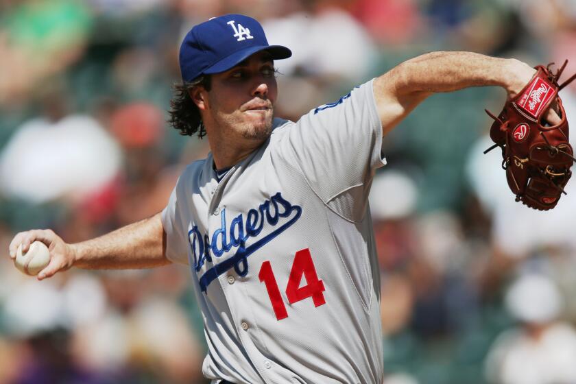 Dodgers starter Dan Haren delivers a pitch during the fourth inning of Saturday's game against the Colorado Rockies.