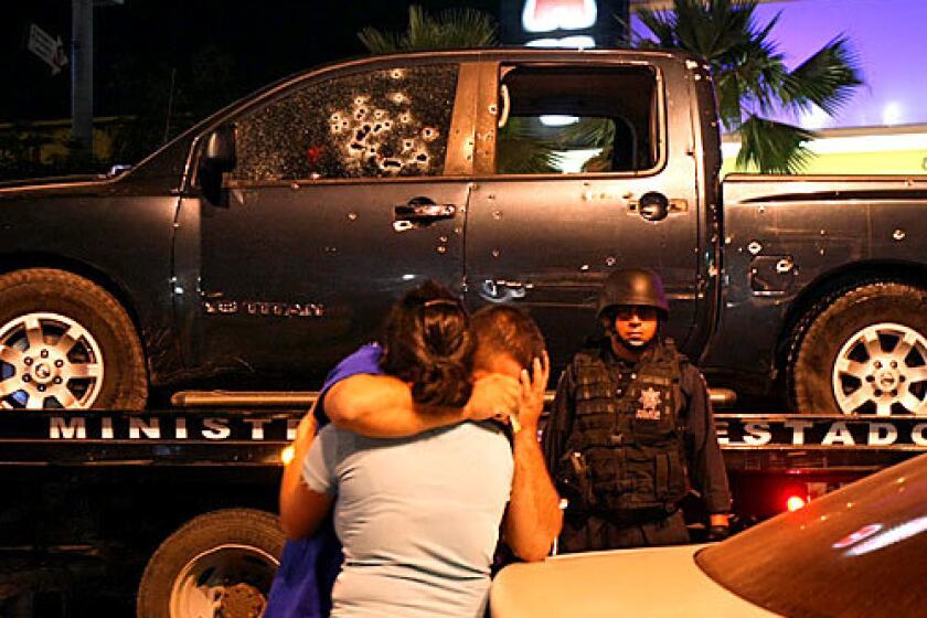 Family members of one of the slain state policemen console each other after seeing the pockmarked pickup the officers had been riding in when they were attacked in central Culiacan. The assailants, most likely cartel hitmen, escaped. At least 10 people died in 24 hours ending Wednesday night in Culiacan, in Sinaloa state, which has become a hub of violence since the federal government launched a crackdown against drug gangs.