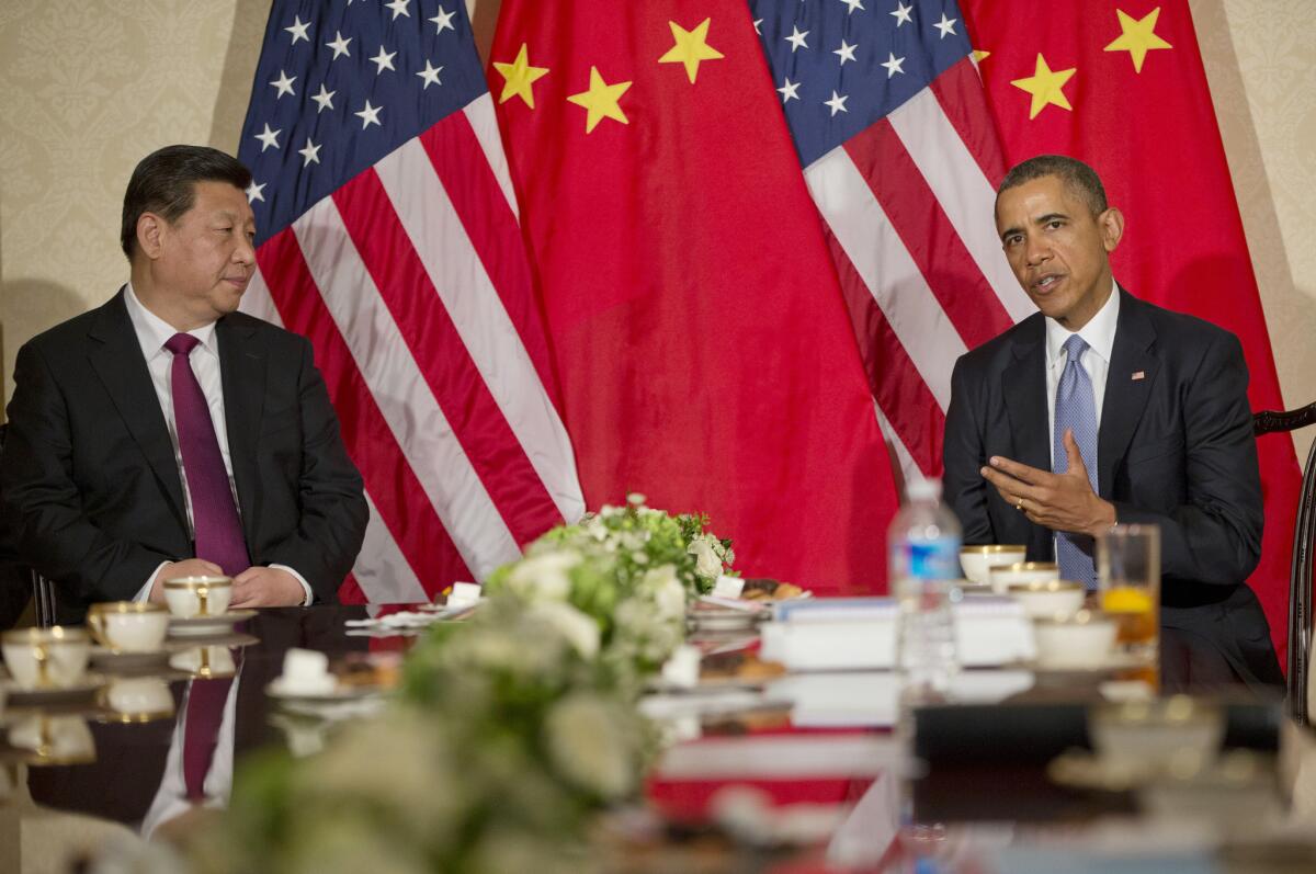 President Obama and Chinese President Xi Jinping appear before the news media before their meeting Monday at the U.S. ambassador's residence in The Hague, Netherlands.