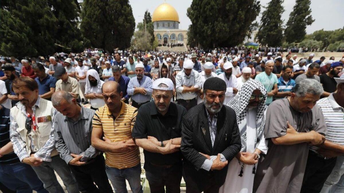 Palestinian men pray in front of the Dome of the Rock mosque in the Old City of Jerusalem on May 24.