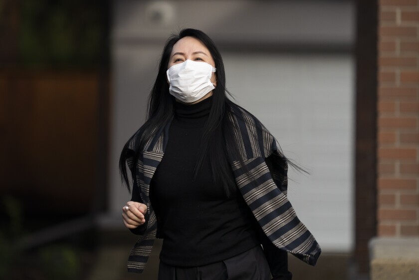 Meng Wanzhou, the chief financial officer of Huawei, leaves her home in Vancouver, British Columbia, to attend a court hearing, Monday, March 1, 2021. (Jonathan Hayward/The Canadian Press via AP)