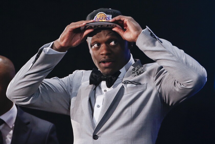 Kentucky forward Julius Randle puts on a Lakers cap after being selected with the seventh overall pick by L.A. at the NBA draft.