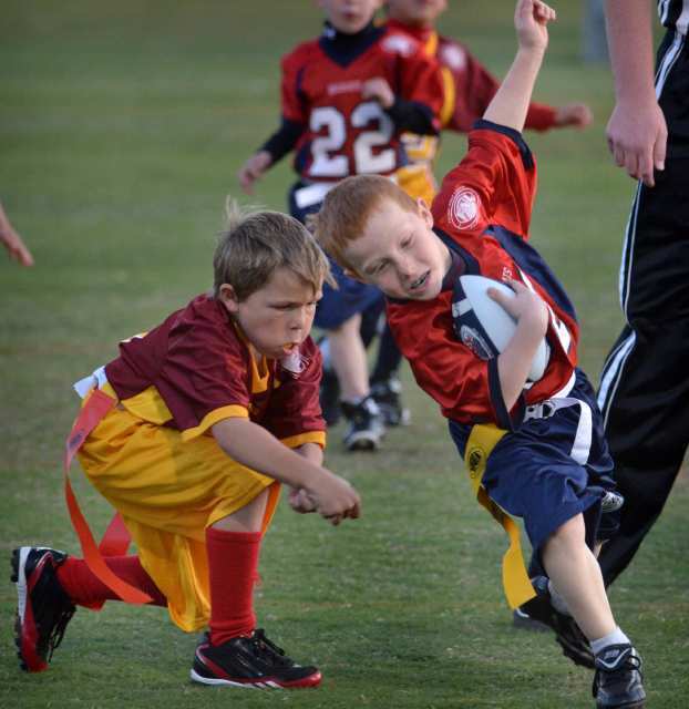 Riley Witte, right, of the Arizona Wildcats tries to keep his flag from Trenton Quick of the USC Trojans.