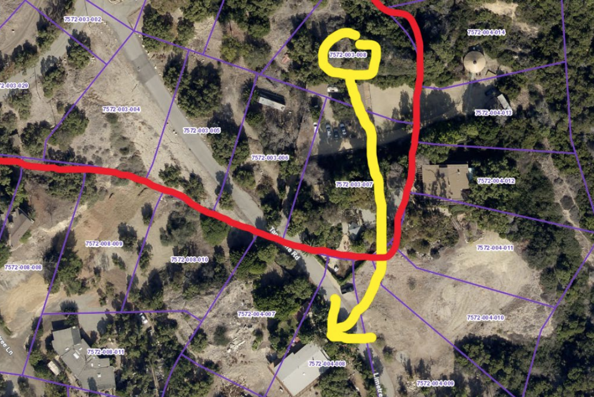 Aerial imagery and a drawn yellow arrow show how far one house has moved from its original parcel.