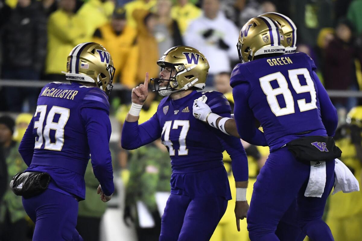 Huskies kicker Peyton Henry (47) celebrates with teammates after making a go-ahead field goal Nov. 12, 2022.