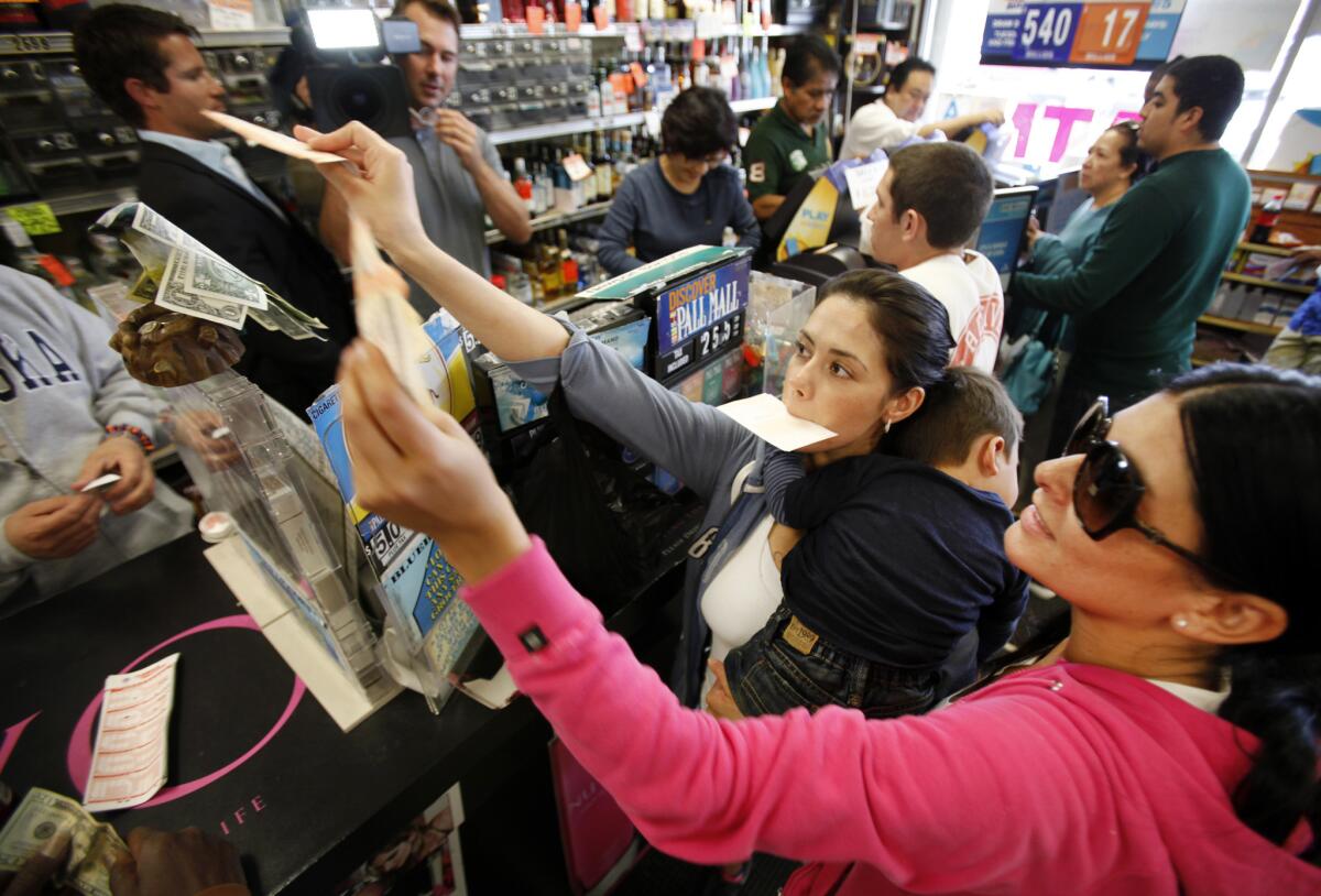 Customers line up to buy Powerball tickets at the Bluebird Liquor store in Hawthorne, considered one of the luckiest lottery retailers in California, in March 2012 when the jackpot topped $540 million.