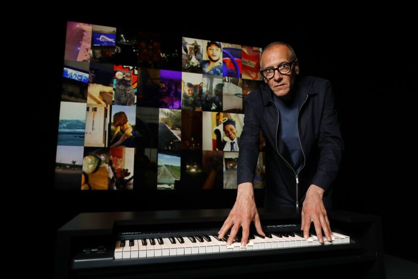LOS ANGELES, CALIF. -- MONDAY, AUGUST 19, 2019: Christian Marclay, "The Organ," an interactive work where visitors are invited to play a keyboard in the center of the room, each key triggers a set of snaps that closely matches the note played, at the Los Angeles County Museum of Art in Los Angeles, Calif., on Aug. 19, 2019. Marclay's exhibit of "Sound Stories" where he is using Snapchat video to create a work of sound art. (Gary Coronado / Los Angeles Times)