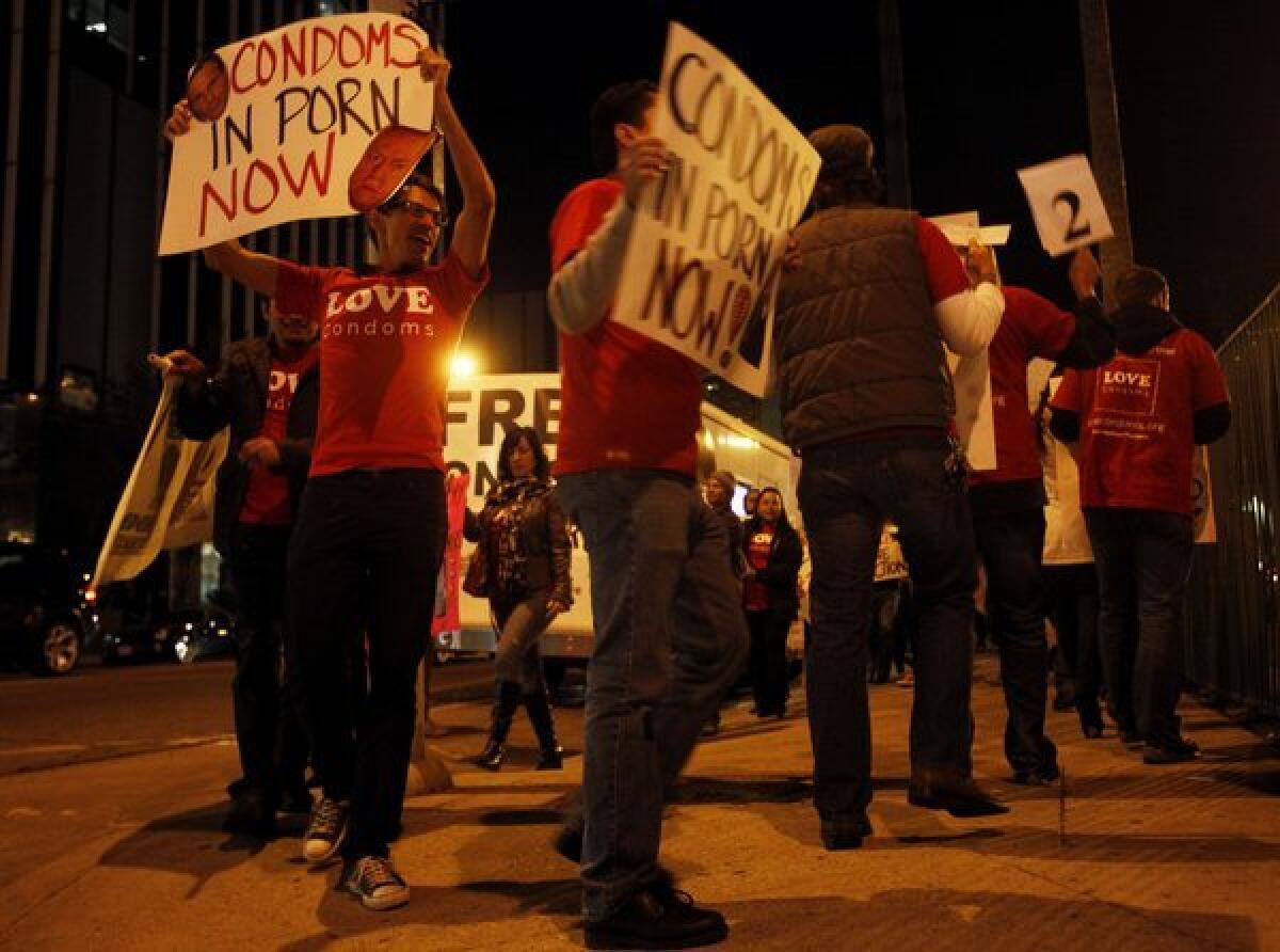 AIDS Healthcare Foundation members protest about a half a block from the XBiz Awards at the Palladium in Los Angeles in 2011.