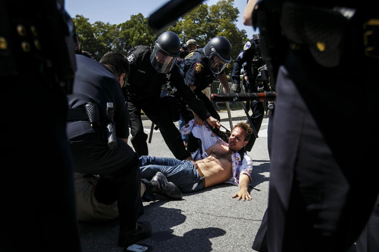 Protesters clash with police outside the hotel in Burlingame where Donald Trump spoke at the California Republican Party convention on April 29, 2016.