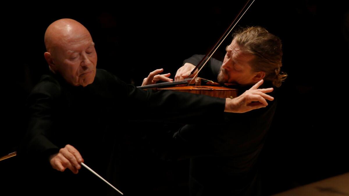 Guest conductor Christoph Eschenbach, left, and violinist Christian Tetzlaff perform Friday night with the Los Angeles Philharmonic at Walt Disney Concert Hall. (Francine Orr / Los Angeles Times)