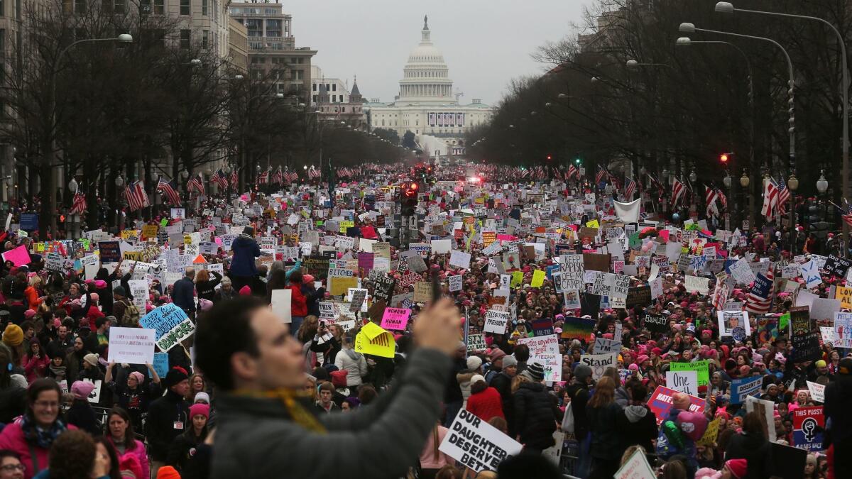 Protesters walk during the Women's March on Washington, with the U.S. Capitol in the background, on Jan. 21, 2017.