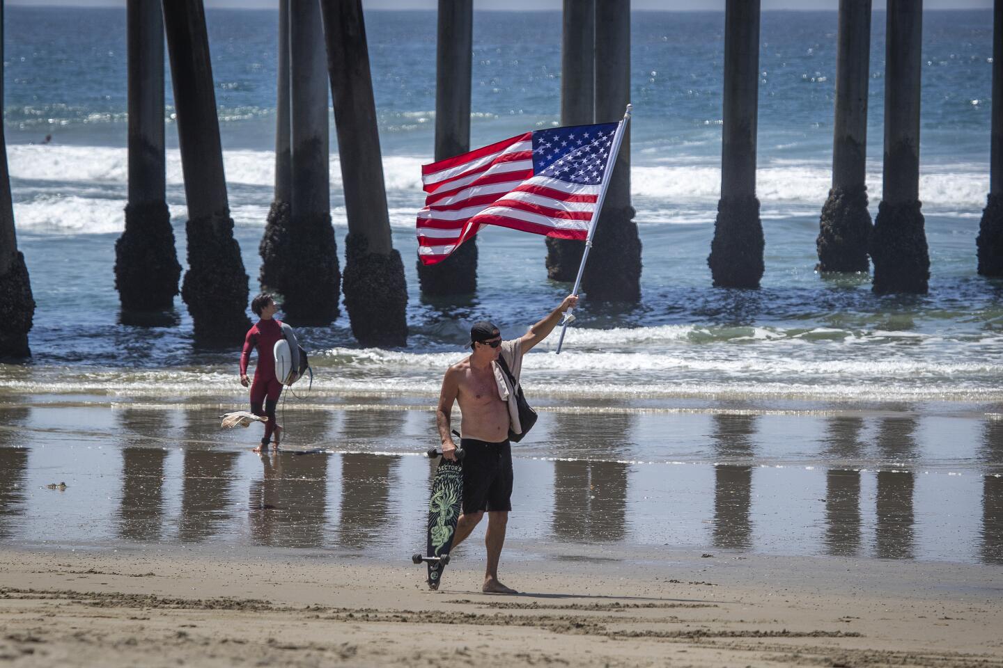 Protester waves U.S. flag in Huntington Beach