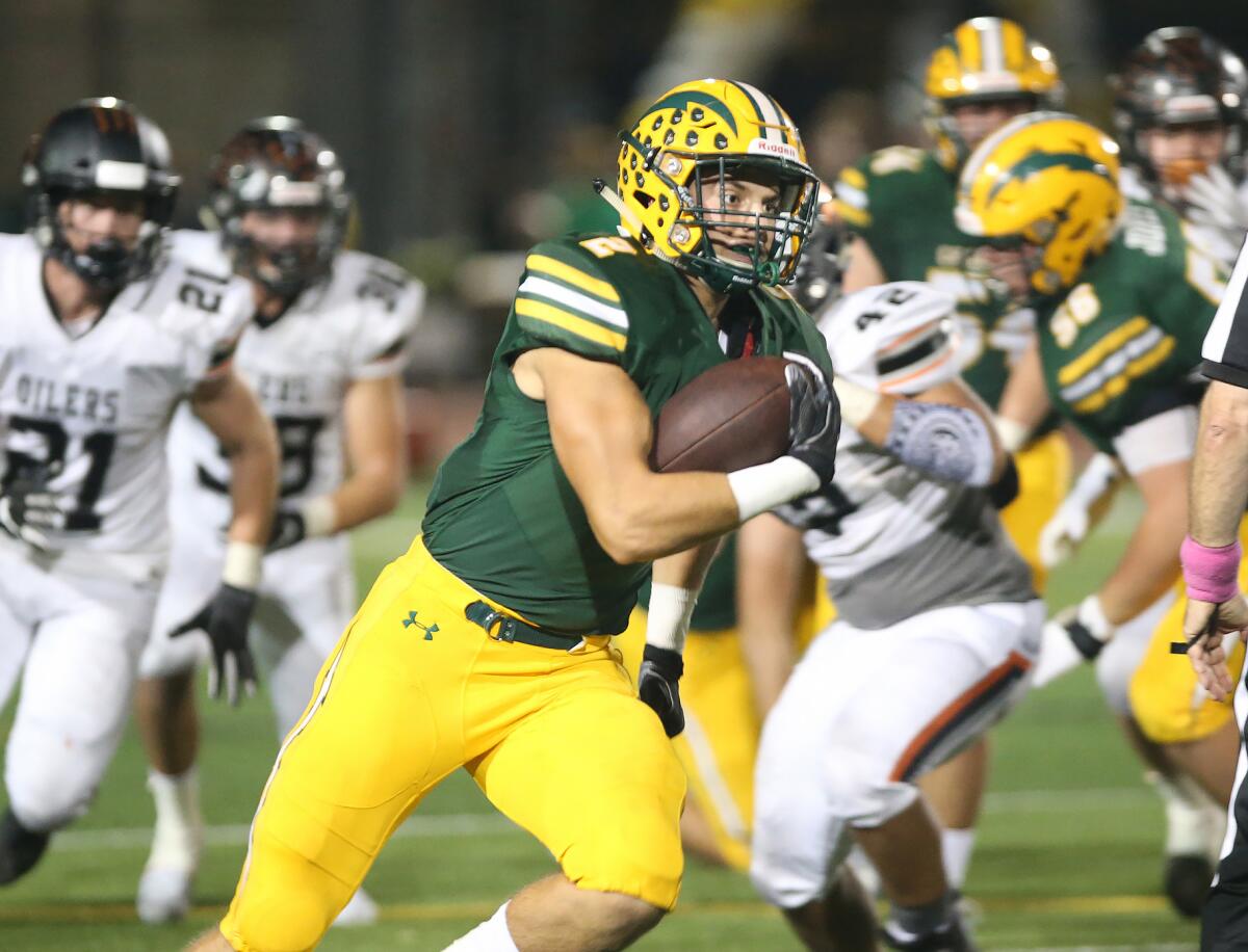 Edison running back Mike Walters, shown carrying the ball against Huntington Beach on Oct. 15, 2018, will try to help the Chargers earn another win over the Oilers on Friday.