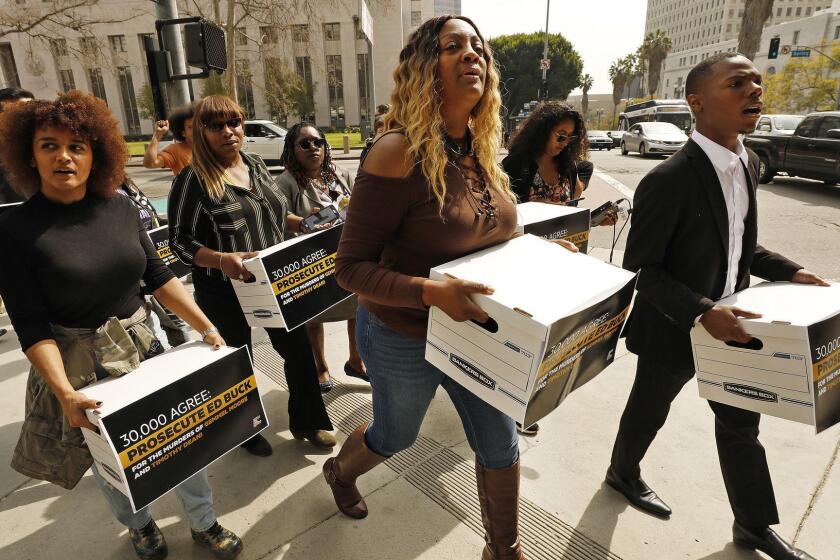 LOS ANGELES, CA - FEBRUARY 26, 2019 LaTisha Nixon (cq), center, the mother of Gemmel Moore -- the 26-year-old black man who was found dead of a methamphetamine overdose in the home of prominent Democratic donor Ed Buck in July 2017 leads members of Color of Change, an online racial justice organization, as they attempt to deliver 30,000-signature petitions to Los Angeles County District Attorney Jackie Lacey calling for the prosecution of Buck for the deaths of Moore and Timothy Dean, a 55-year-old black man who died in Buck's home in January 2019. (Al Seib / Los Angeles Times)