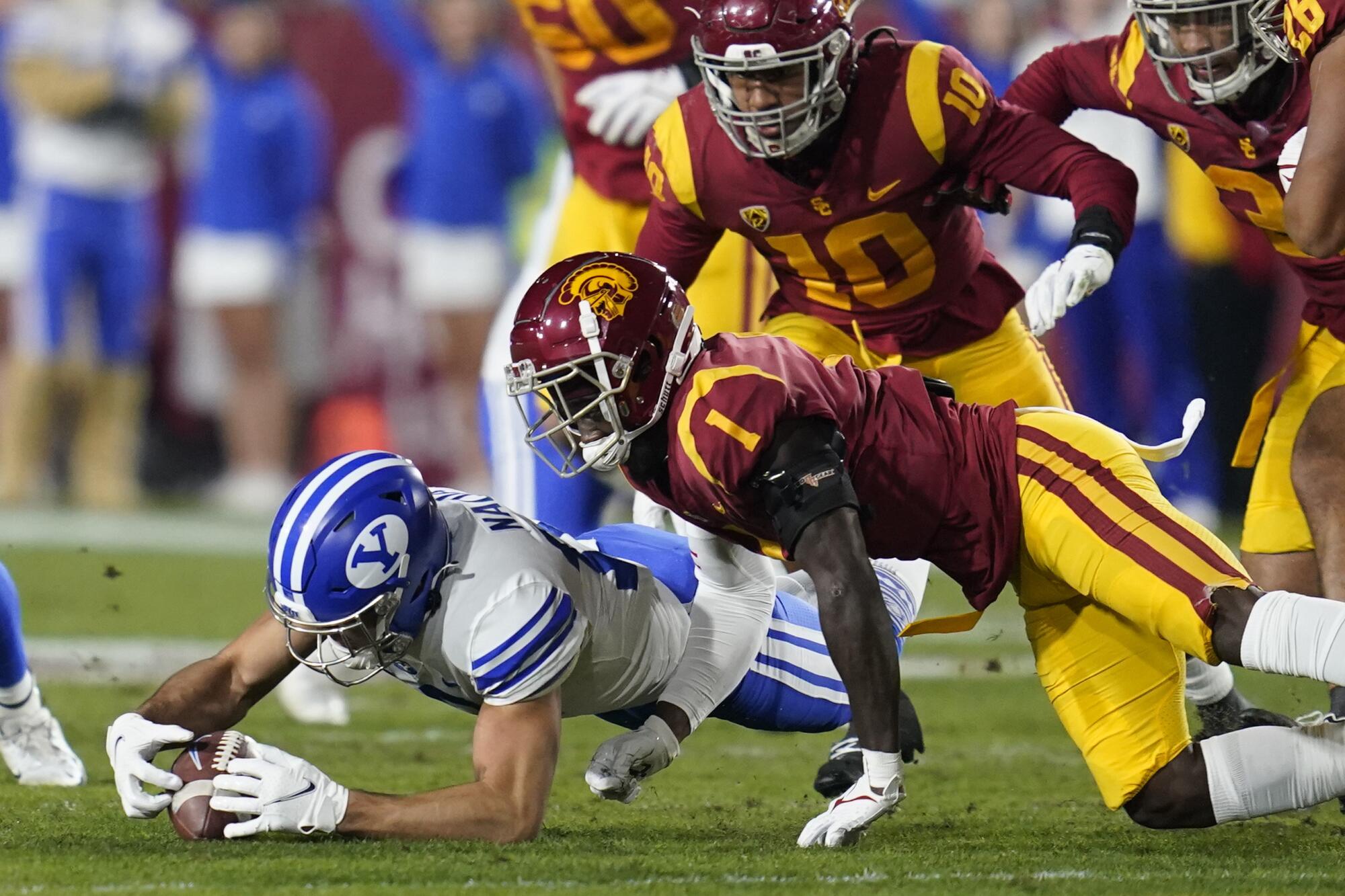 DUPLICATE***Brigham Young wide receiver Puka Nacua (12) recovers a fumble.