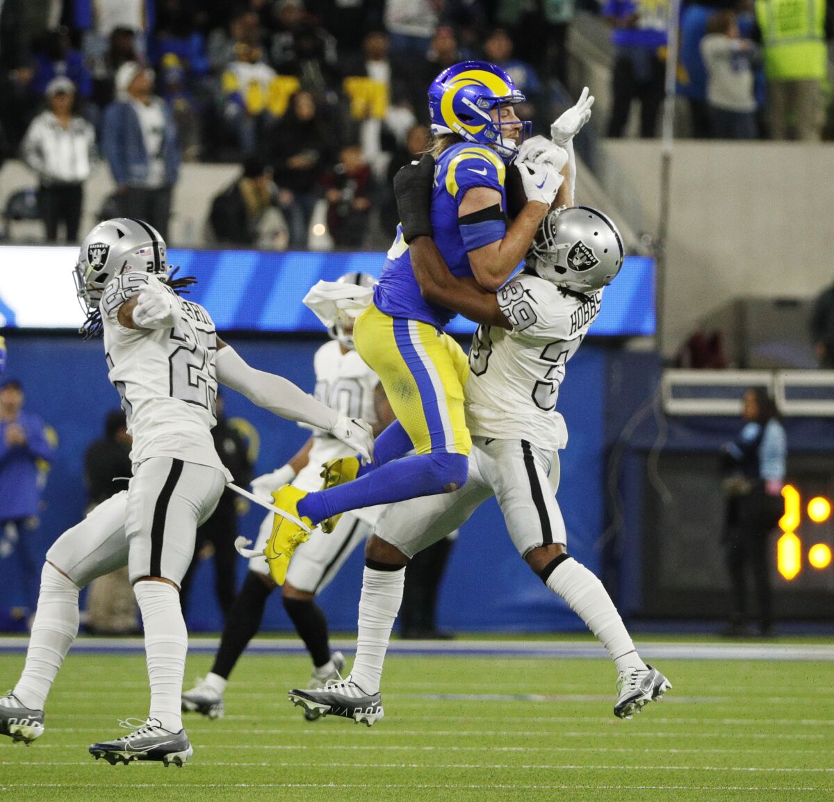 The Rams' Ben Skowronek (18) makes a key reception late in the game against Raiders cornerback Nate Hobbs (39).
